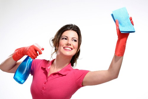 Cleaning technician treating a sofa in a Marylebone apartment